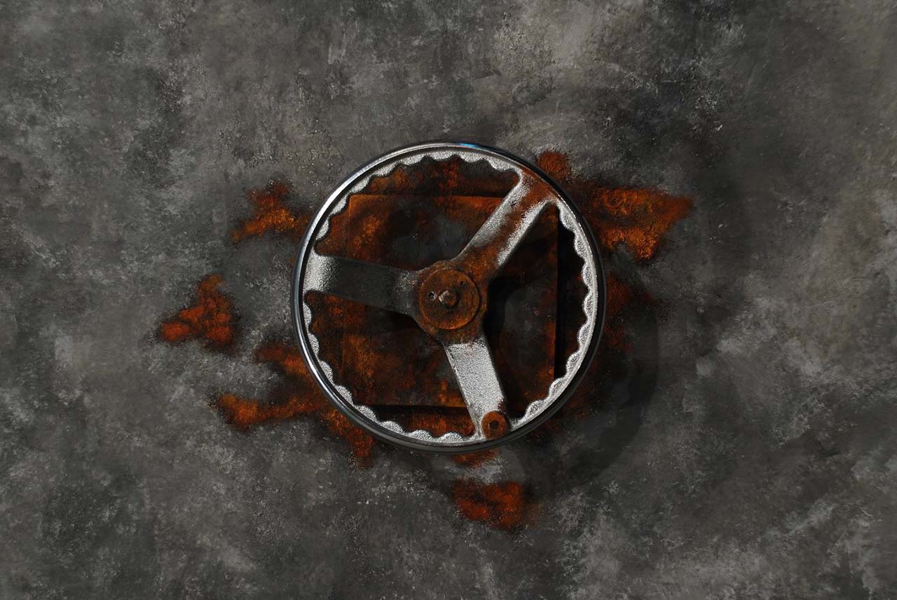A rusty door with a wheel to unlock