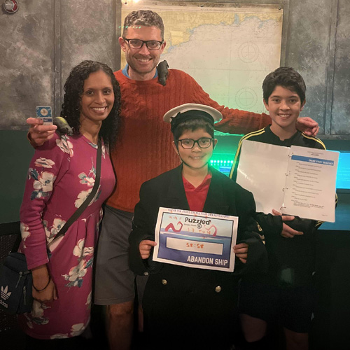 Puzzled Escape Rooms Cardiff - A family having their photo taken.