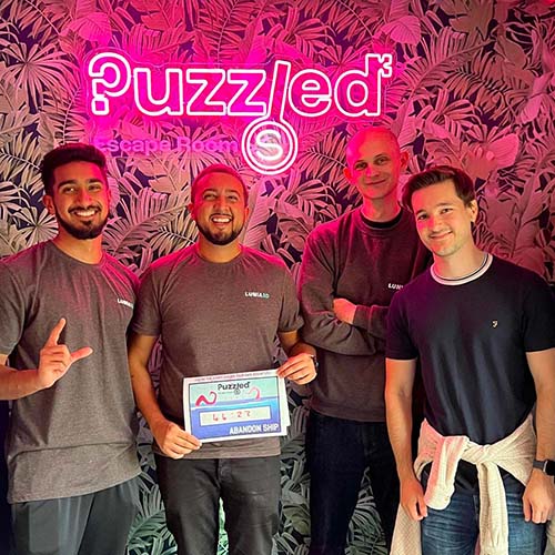 A corporate team having their photo taken after playing at Puzzled Escape Rooms